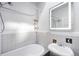 Clean bathroom with tiled bathtub and modern sink at 178 W Cedar Ave, Denver, CO 80223