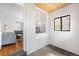 Bright entry area with a white brick wall, and a view into the living room at 178 W Cedar Ave, Denver, CO 80223