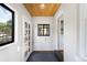 Inviting foyer with stylish wood ceiling, white walls, and a view of the front yard at 178 W Cedar Ave, Denver, CO 80223