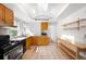Bright kitchen with skylight, stainless steel appliances, light wood cabinets and tiled floors at 178 W Cedar Ave, Denver, CO 80223