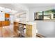 Eat-in kitchen with built-in desk and chair, skylight, and view to backyard at 178 W Cedar Ave, Denver, CO 80223