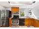 Well-equipped kitchen with stainless steel appliances and warm wood cabinets at 178 W Cedar Ave, Denver, CO 80223