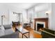 Cozy living room featuring a fireplace, hardwood floors, and comfortable furniture at 178 W Cedar Ave, Denver, CO 80223