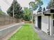 Landscaped backyard with a retaining wall and modern fence at 3069 S Detroit Way, Denver, CO 80210