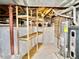 Unfinished basement area with water heater and storage shelves at 3069 S Detroit Way, Denver, CO 80210