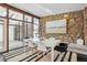 Bright dining area with stone feature wall and stylish table at 3069 S Detroit Way, Denver, CO 80210