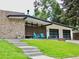 Mid-century modern home with stone accents and landscaped yard at 3069 S Detroit Way, Denver, CO 80210