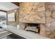 Stone fireplace with wood mantel and hearth in living room at 3069 S Detroit Way, Denver, CO 80210