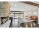 Spacious living room with stone fireplace and sliding glass doors at 3069 S Detroit Way, Denver, CO 80210