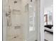 Spa-like shower with marble tile and built-in shelving at 3069 S Detroit Way, Denver, CO 80210