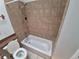 Updated bathroom featuring tiled shower and tub, and functional vanity with good natural light at 4296 S Halifax Way, Aurora, CO 80013