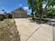 Wide driveway providing ample parking space, complemented by mature trees for shade at 4296 S Halifax Way, Aurora, CO 80013