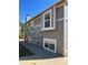 Side exterior of a two story house with a gray exterior and white trim, highlighting the window placements at 4296 S Halifax Way, Aurora, CO 80013