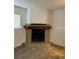 Cozy fireplace with tile surround, wood mantle, and neutral carpet in a living space at 4296 S Halifax Way, Aurora, CO 80013