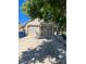 Attached two car garage with brick facade and long concrete driveway partially shaded by a mature tree at 4296 S Halifax Way, Aurora, CO 80013