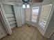 Bright eat-in kitchen with tiled floor, white trim, bay window, and pantry at 4296 S Halifax Way, Aurora, CO 80013