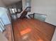 Spacious living room featuring hardwood floors, staircase, and glass block wall allowing natural light at 4296 S Halifax Way, Aurora, CO 80013