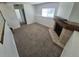 Carpeted living room featuring a corner fireplace, window, and neutral paint at 4296 S Halifax Way, Aurora, CO 80013