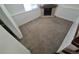 Carpeted living room featuring a corner fireplace, window and white trim at 4296 S Halifax Way, Aurora, CO 80013