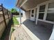 Covered patio area with concrete flooring and a wooden fence, perfect for outdoor relaxation at 4296 S Halifax Way, Aurora, CO 80013