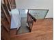 Carpeted staircase with wood railing and tiled flooring at the base of the stairs at 4296 S Halifax Way, Aurora, CO 80013