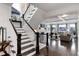 Grand staircase leading to an open living area with hardwood floors at 10841 Greycliffe Dr, Highlands Ranch, CO 80126