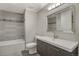 Updated bathroom with gray tile and modern vanity at 2221 S Dearborn St, Aurora, CO 80014