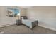 Bright bedroom with gray carpeting and a gray twin bed at 2221 S Dearborn St, Aurora, CO 80014