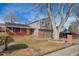 Two-story house with gray siding, attached garage, and mature trees at 2221 S Dearborn St, Aurora, CO 80014