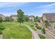 Beautifully landscaped backyard with a winding sidewalk and lush green grass at 22124 E Euclid Dr, Aurora, CO 80016