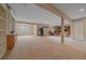 Large finished basement with neutral carpet, support beams, and ample open space at 22124 E Euclid Dr, Aurora, CO 80016
