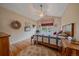 Bedroom with hardwood floors, a ceiling fan, a large window for natural light, and a bed with a colorful quilt at 22124 E Euclid Dr, Aurora, CO 80016