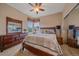 Bedroom featuring a double window, ceiling fan and a large dresser with a mirror at 22124 E Euclid Dr, Aurora, CO 80016