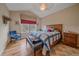 Bedroom featuring a vaulted ceiling, a large window, hardwood floors, and comfortable furniture at 22124 E Euclid Dr, Aurora, CO 80016