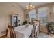 Formal dining room featuring a chandelier, large windows, and ample space for entertaining at 22124 E Euclid Dr, Aurora, CO 80016