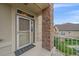 Close-up of the front door, highlighting the brick pillar, and secure entrance for a welcoming first impression at 22124 E Euclid Dr, Aurora, CO 80016