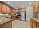 Well-lit kitchen featuring stainless steel appliances, granite countertops, and tile flooring for easy maintenance at 22124 E Euclid Dr, Aurora, CO 80016