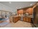 Open kitchen view showing stainless appliances, tile floor, granite countertops, and a view of the living room at 22124 E Euclid Dr, Aurora, CO 80016