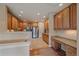 Modern kitchen with stainless steel appliances, warm wood cabinetry, and a convenient desk area at 22124 E Euclid Dr, Aurora, CO 80016
