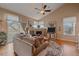 Comfortable living room featuring a fireplace, ceiling fan, and sliding glass doors for natural light at 22124 E Euclid Dr, Aurora, CO 80016