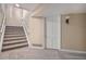 Unfinished basement with carpeted stairs and storage at 6386 E Tufts Ave, Englewood, CO 80111