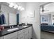 Double vanity bathroom with view into bedroom at 2058 Spencer Ave, Castle Rock, CO 80104