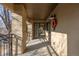 View of balcony's covered space with wrought iron railing, and shade-casting pillars at 290 Poplar St # A, Denver, CO 80220