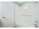 Bathroom featuring shower with glass wall, white tile and a white door at 290 Poplar St # A, Denver, CO 80220