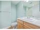 Bathroom featuring a tile countertop, wood cabinets, and a walk in shower at 290 Poplar St # A, Denver, CO 80220