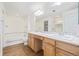 Bathroom featuring a double vanity with a large mirror and tiled shower at 290 Poplar St # A, Denver, CO 80220