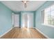 Bedroom showcasing natural light, wood floors, a closet, and light blue walls at 290 Poplar St # A, Denver, CO 80220