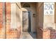 Close up of front door with brick columns, welcome mat and clear view of the unit number at 290 Poplar St # A, Denver, CO 80220