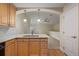 The kitchen features pendant lighting, a double sink and an open plan design at 290 Poplar St # A, Denver, CO 80220