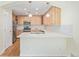 Kitchen featuring stainless steel appliances, light wood cabinetry, and a breakfast bar at 290 Poplar St # A, Denver, CO 80220